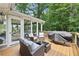 Cozy outdoor deck with comfortable seating, a Blackstone grill, and serene backyard views at 4733 Eidson Road, Dunwoody, GA 30360