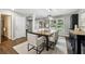 Elegant dining room featuring modern lighting, neutral decor, and ample seating for eight at 4733 Eidson Road, Dunwoody, GA 30360