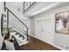 Bright entryway with hardwood floors, a modern staircase, and a stylish front door at 4733 Eidson Road, Dunwoody, GA 30360