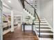 Inviting foyer boasts hardwood floors, a modern staircase, and views of the living and dining areas at 4733 Eidson Road, Dunwoody, GA 30360