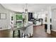 Bright eat-in kitchen features a gray granite island, white cabinetry, stainless steel appliances and access to the deck at 4733 Eidson Road, Dunwoody, GA 30360