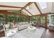 Bright sunroom with wood beams, skylights, and abundant windows offering beautiful views of the outdoors at 4733 Eidson Road, Dunwoody, GA 30360