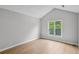Bright bedroom featuring a large window, vaulted ceiling, and hardwood floors at 484 Culberson Sw St, Atlanta, GA 30310