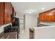 Traditional style kitchen features wood cabinets, tile flooring, and modern black appliances at 484 Culberson Sw St, Atlanta, GA 30310