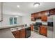 Functional kitchen space with stainless appliances, dark wood cabinets, and easy access to adjacent dining area at 484 Culberson Sw St, Atlanta, GA 30310