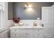 Bright bathroom featuring a marble countertop vanity with white cabinets and decorative tiling at 513 Saint Charles Ne Ave, Atlanta, GA 30308