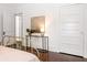 Bedroom featuring hardwood floors, a bed with a gold frame, and a glass console table at 513 Saint Charles Ne Ave, Atlanta, GA 30308