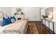 Stylish bedroom featuring a cozy bed, an ornate fireplace, hardwood floors, and a console table at 513 Saint Charles Ne Ave, Atlanta, GA 30308