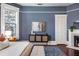 Comfortable bedroom with blue walls, fireplace, and large windows offering natural light at 513 Saint Charles Ne Ave, Atlanta, GA 30308