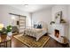 Charming bedroom with hardwood floors, ornate fireplace, and en-suite bathroom with sliding barn door at 513 Saint Charles Ne Ave, Atlanta, GA 30308