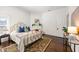 Bright bedroom featuring hardwood floors, a cozy bed, and a charming fireplace at 513 Saint Charles Ne Ave, Atlanta, GA 30308