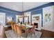 Open dining room with blue walls, a fireplace, a table that seats eight, and stairs visible at 513 Saint Charles Ne Ave, Atlanta, GA 30308