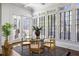 Bright dining room with large windows, glass table, and hardwood floors at 513 Saint Charles Ne Ave, Atlanta, GA 30308