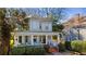 Two-story home with classic front porch, offering an inviting curb appeal surrounded by mature landscaping at 513 Saint Charles Ne Ave, Atlanta, GA 30308