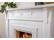 Close-up of a white ornate fireplace with detailed carvings and decorative tile surround at 513 Saint Charles Ne Ave, Atlanta, GA 30308