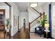 Elegant foyer featuring hardwood floors, a staircase with wood trim, and tasteful decor creating a welcoming entrance at 513 Saint Charles Ne Ave, Atlanta, GA 30308