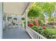 Inviting front porch with hanging ferns, rocking chairs, and lush landscaping at 513 Saint Charles Ne Ave, Atlanta, GA 30308