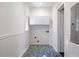 Clean and bright laundry room with white cabinets and mosaic tile floor at 513 Saint Charles Ne Ave, Atlanta, GA 30308