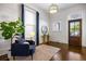Inviting living room featuring a decorative front door, a large window, and stylish furnishings at 513 Saint Charles Ne Ave, Atlanta, GA 30308
