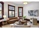 Well-lit living room featuring hardwood floors, comfortable seating, and large windows with natural light at 513 Saint Charles Ne Ave, Atlanta, GA 30308