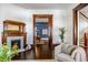 Cozy living room with a fireplace, hardwood floors, and a doorway leading to an adjacent dining area at 513 Saint Charles Ne Ave, Atlanta, GA 30308