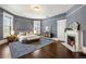 Spacious main bedroom featuring hardwood floors, a fireplace, and natural light at 513 Saint Charles Ne Ave, Atlanta, GA 30308