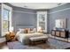 Well-lit main bedroom with hardwood floors, a stylish rug, and ample natural light at 513 Saint Charles Ne Ave, Atlanta, GA 30308