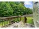 Wooden back deck looking out to a large lawn surrounded by tall green trees at 105 Arbor Creek Trl, Dallas, GA 30157