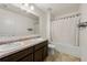 Well-lit bathroom with double sinks, and a shower-tub combination with white curtain at 105 Arbor Creek Trl, Dallas, GA 30157