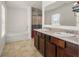 Bright bathroom with a double vanity, large mirror and separate tub and shower at 105 Arbor Creek Trl, Dallas, GA 30157