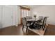 Elegant dining room featuring a dark wood table, upholstered chairs, and hardwood floors with a decorative rug at 105 Arbor Creek Trl, Dallas, GA 30157