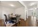 Elegant dining room featuring a dark wood table, upholstered chairs, and hardwood floors with a decorative rug at 105 Arbor Creek Trl, Dallas, GA 30157