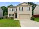 Charming two-story home with a brick facade, well-manicured lawn, and an attached two-car garage at 105 Arbor Creek Trl, Dallas, GA 30157