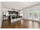 Modern kitchen with stainless steel appliances, a breakfast bar, and dark cabinetry at 105 Arbor Creek Trl, Dallas, GA 30157