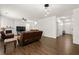 Comfortable living room with a fireplace, ceiling fan, leather couches, and access to a deck through French doors at 105 Arbor Creek Trl, Dallas, GA 30157