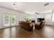 Comfortable living room with a fireplace, ceiling fan, leather couches, and access to a deck through French doors at 105 Arbor Creek Trl, Dallas, GA 30157