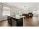 Open living area with modern lighting, granite counters and view to living room fireplace at 105 Arbor Creek Trl, Dallas, GA 30157