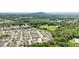 Community aerial view of homes surrounded by mature trees with mountain backdrop at 3698 Roseman Lndg, Cumming, GA 30040