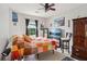 Cozy bedroom with a colorful quilt, ceiling fan, and natural light at 3698 Roseman Lndg, Cumming, GA 30040