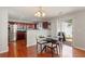 Open-concept dining area with glass table and access to outdoor patio at 3698 Roseman Lndg, Cumming, GA 30040