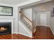 Bright foyer with hardwood floors, staircase, white trim, and access to the front door at 3698 Roseman Lndg, Cumming, GA 30040