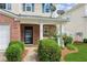 Inviting front porch with brick accents, manicured bushes, and lovely landscaping at 3698 Roseman Lndg, Cumming, GA 30040