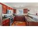 Well-lit kitchen featuring dark wood cabinets, granite countertops, and stainless steel appliances at 3698 Roseman Lndg, Cumming, GA 30040