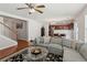 Comfortable living room with hardwood floors, open layout, and view to the kitchen and staircase at 3698 Roseman Lndg, Cumming, GA 30040