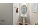 Neat powder room with pedestal sink, oval mirror, and a towel bar, all in neutral tones at 3698 Roseman Lndg, Cumming, GA 30040