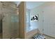 Bright bathroom showcasing a glass-enclosed shower, a separate soaking tub, and stylish vanity at 768 Nehemiah Sw Ln, Atlanta, GA 30331