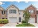 Charming townhome with a one-car garage, blue shutters, neutral siding, and manicured landscaping at 768 Nehemiah Sw Ln, Atlanta, GA 30331