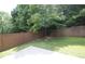 The backyard features lawn space and a tree-lined perimeter at 942 Idlewood Dr, Canton, GA 30115