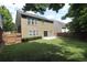 A spacious, grassy backyard featuring a wood fence and a small concrete patio at 942 Idlewood Dr, Canton, GA 30115
