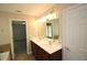 Bathroom features double sinks, white countertops, wood cabinets, and a well-lit mirror at 942 Idlewood Dr, Canton, GA 30115